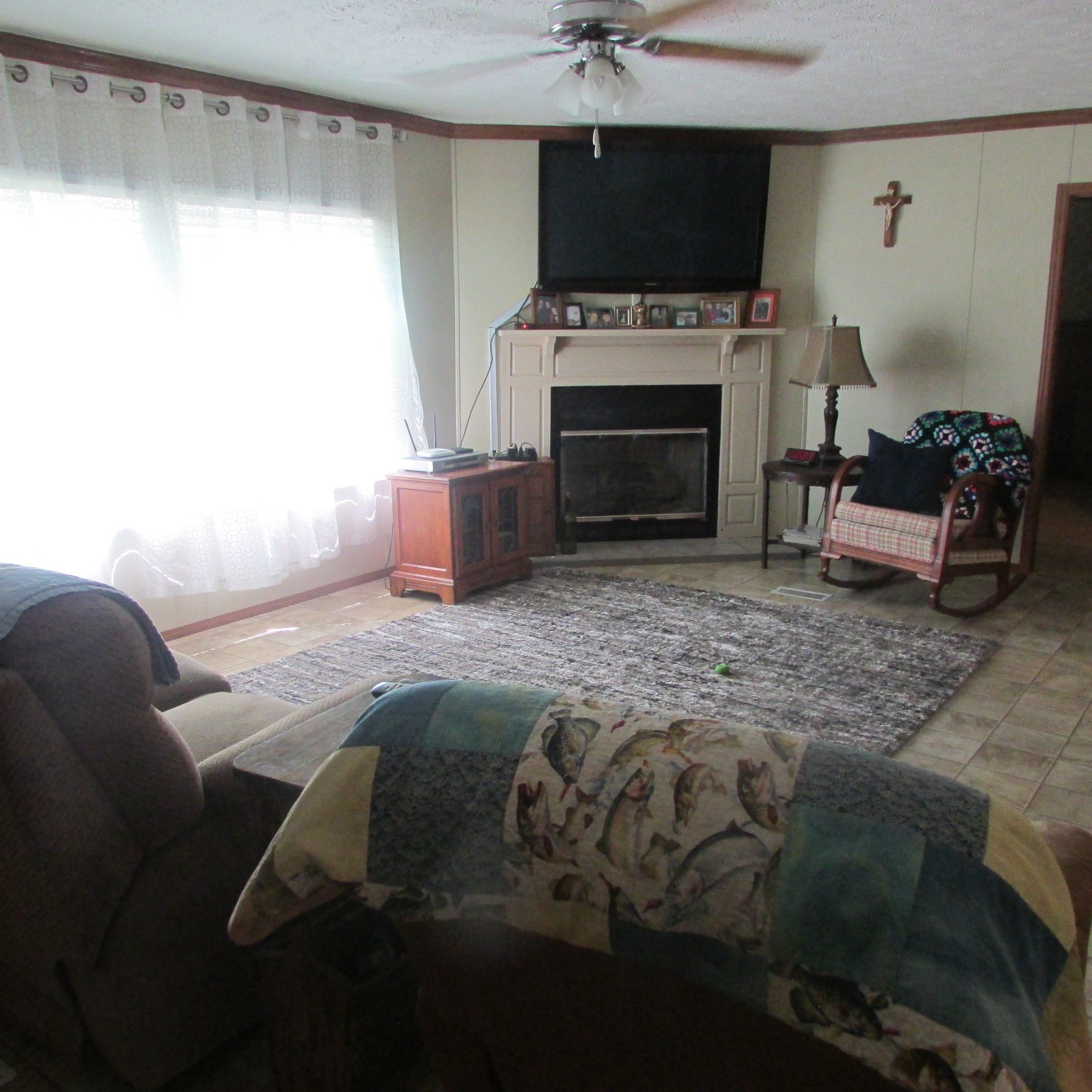 75 Snell Road Ethridge, TN 38456 - Photo 12 of 51 a living room with furniture a flat screen tv and a fireplace