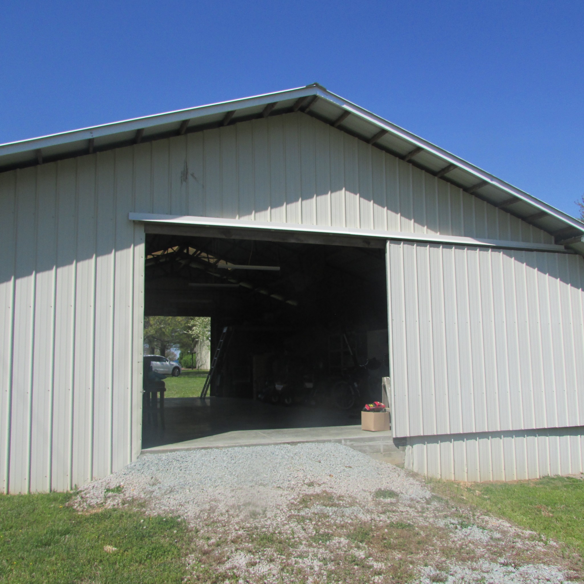 75 Snell Road Ethridge, TN 38456 - Photo 4 of 51 a black house with trees in front of it