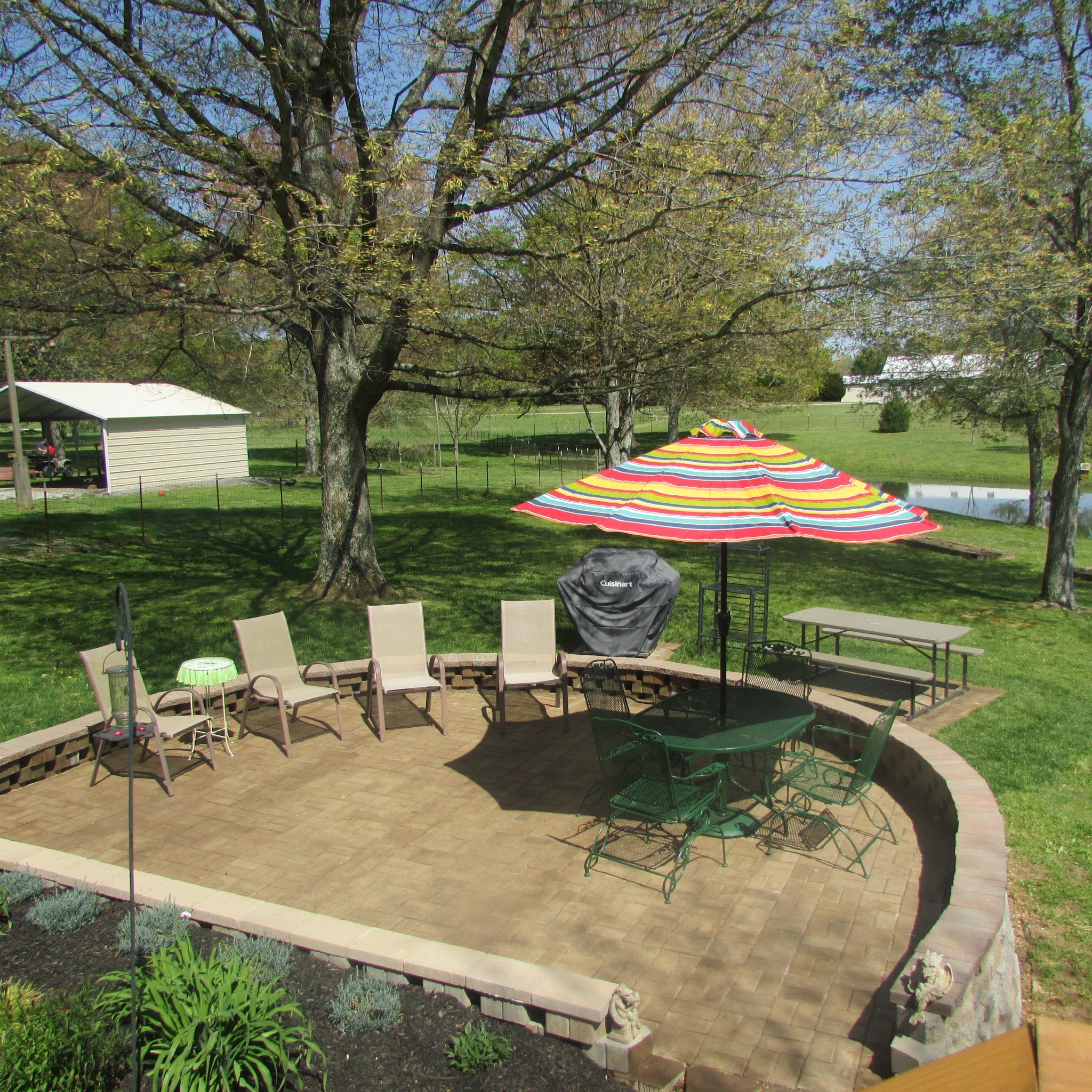 75 Snell Road Ethridge, TN 38456 - Photo 8 of 51 an outdoor space with furniture and umbrella