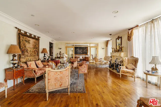 a living room with fireplace furniture and a large window