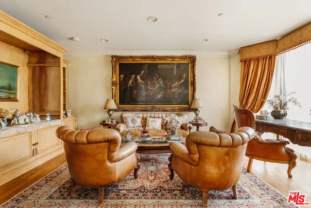 a living room with furniture a rug and a large window