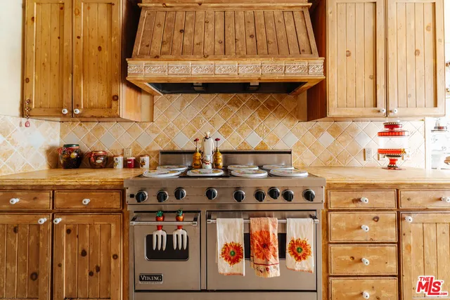 a kitchen with stainless steel appliances granite countertop a stove and a sink