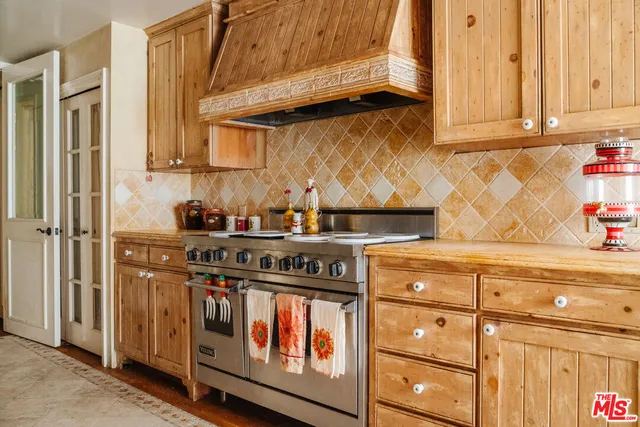 a kitchen with stainless steel appliances granite countertop a stove and a refrigerator