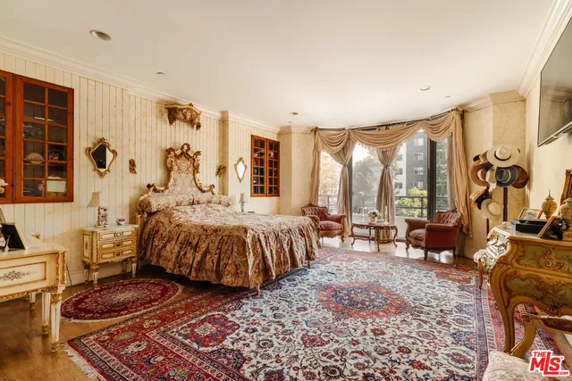 a spacious bedroom with a bed and a large window