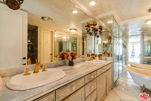 a bathroom with double vanity sinks a large mirror and a shower