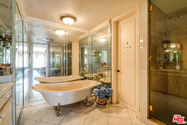 a spacious bathroom with a tub and shower