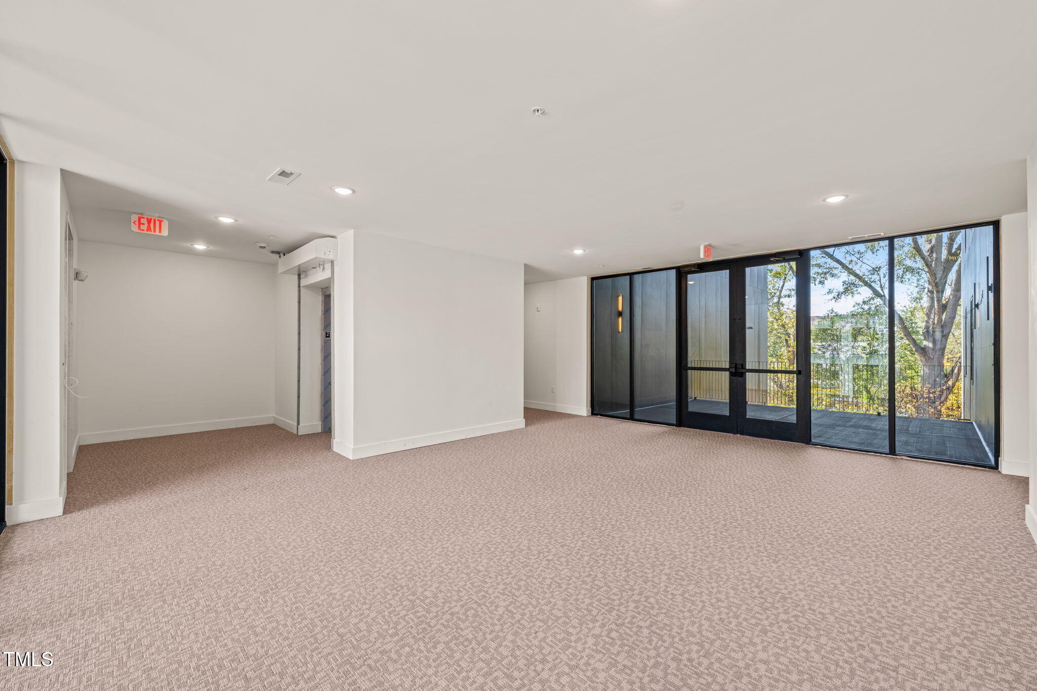 29 Enterprise Street, Unit 201 Raleigh, NC 27607 - Photo 15 of 33 a view of an empty room with a sliding door