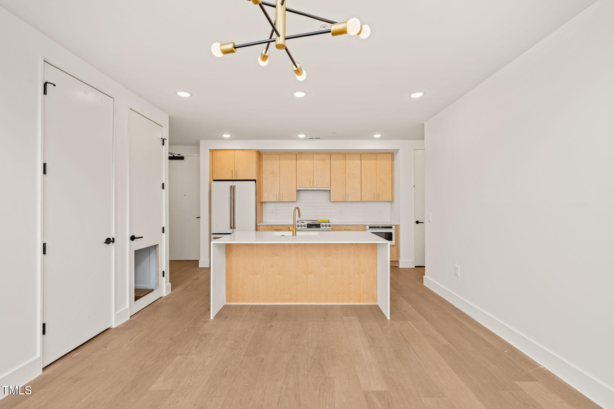 29 Enterprise Street, Unit 201 Raleigh, NC 27607 - Photo 4 of 33 a view of a kitchen with a sink and a refrigerator