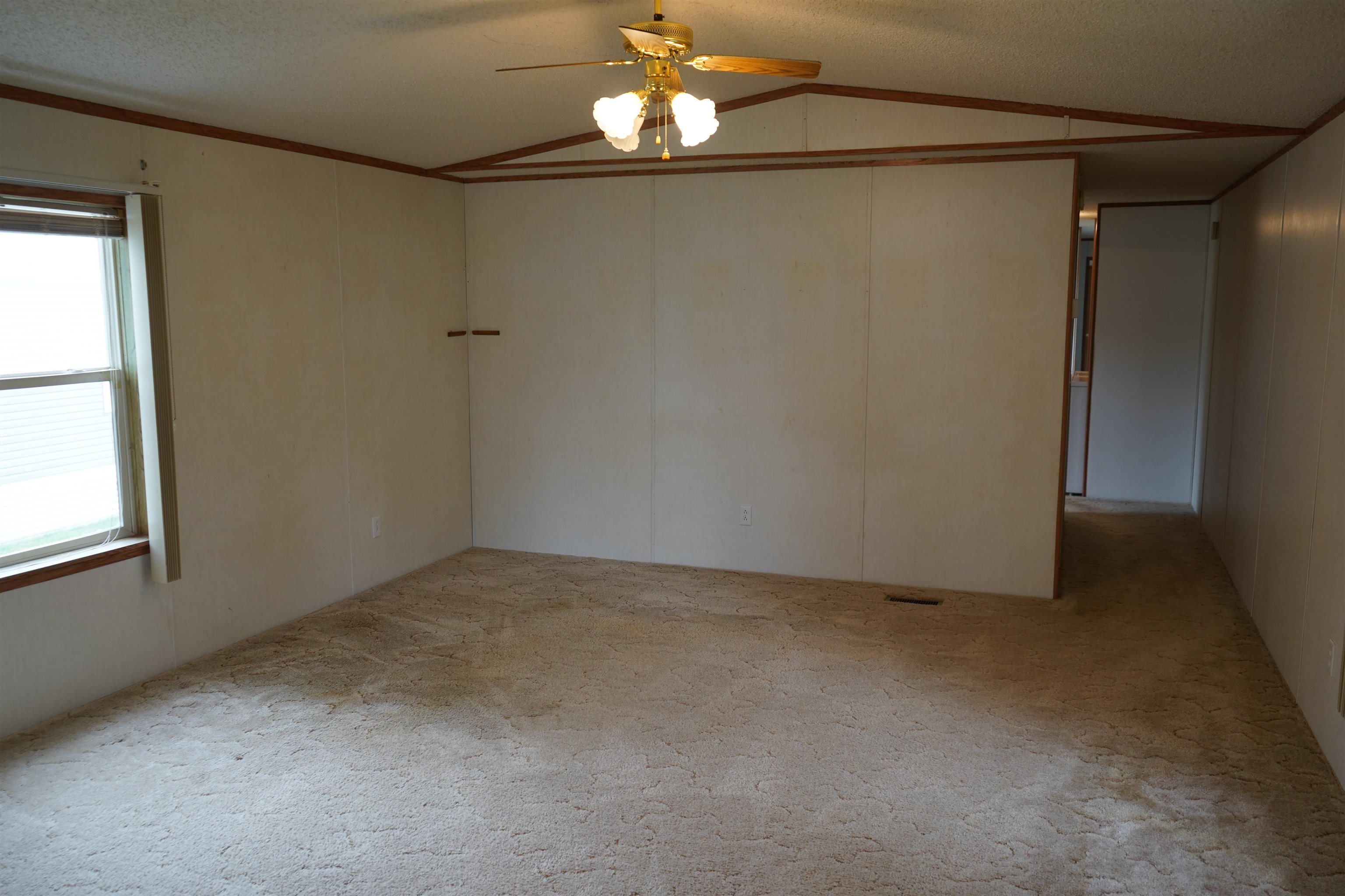 47 Coban Drive Duluth, MN 55808 - Photo 15 of 23 Empty room featuring lofted ceiling, a ceiling fan, and carpet flooring
