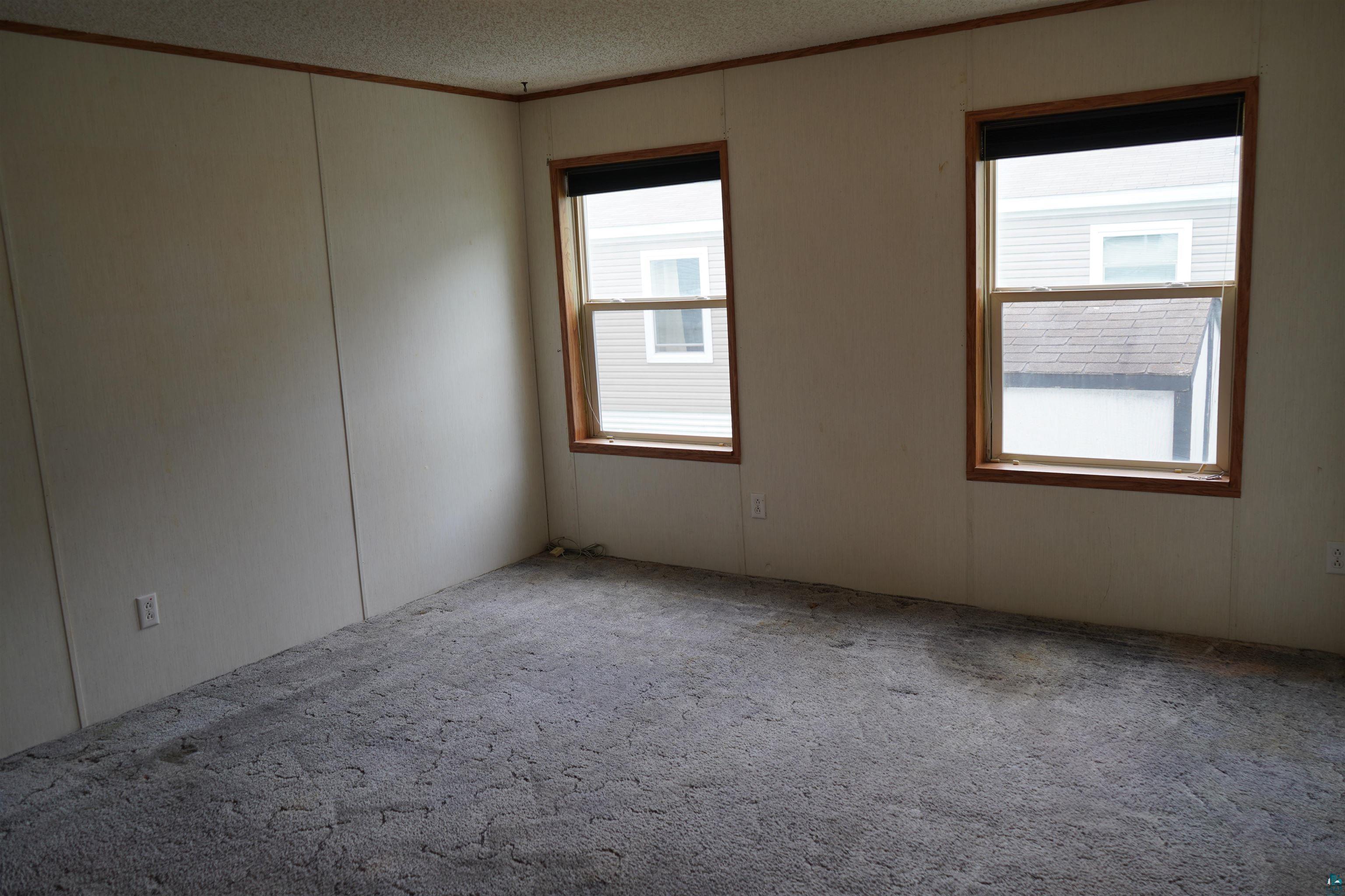 47 Coban Drive Duluth, MN 55808 - Photo 23 of 23 Empty room featuring ornamental molding, carpet floors, and a textured ceiling