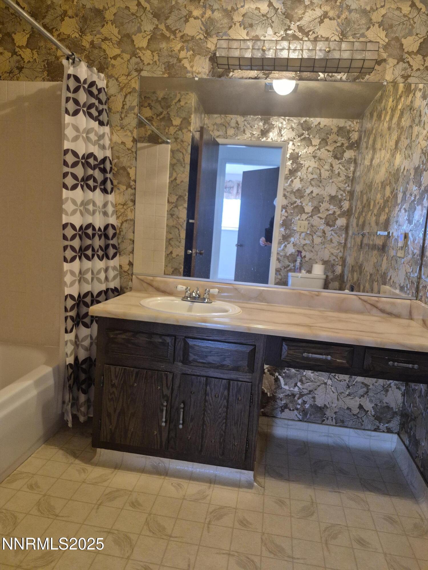 7215 Marlin Drive Reno, NV 89506 - Photo 12 of 40 a bathroom with a sink and a mirror