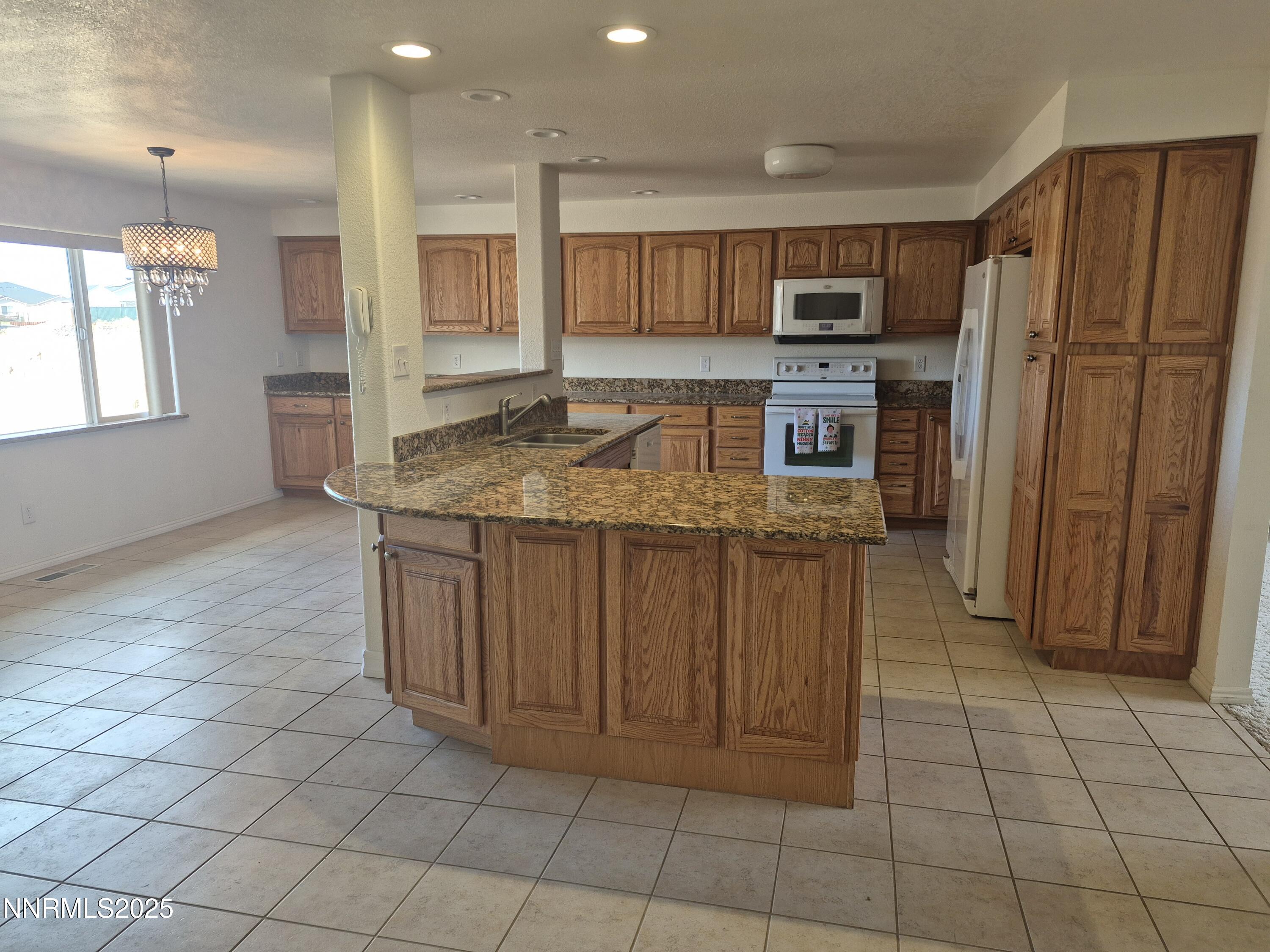 7215 Marlin Drive Reno, NV 89506 - Photo 7 of 40 a kitchen with stainless steel appliances granite countertop a refrigerator and a stove