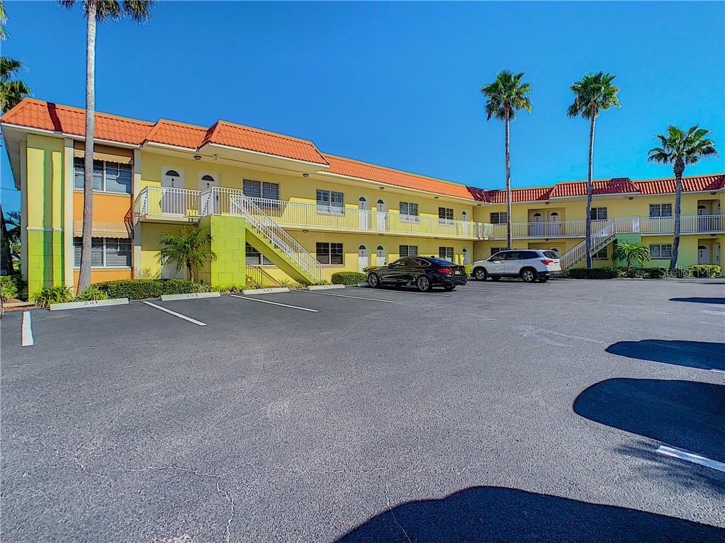 4103 Gulf Boulevard, Unit 106 St. Pete Beach, FL 33706 - Photo 1 of 1 a large building with an outdoor space