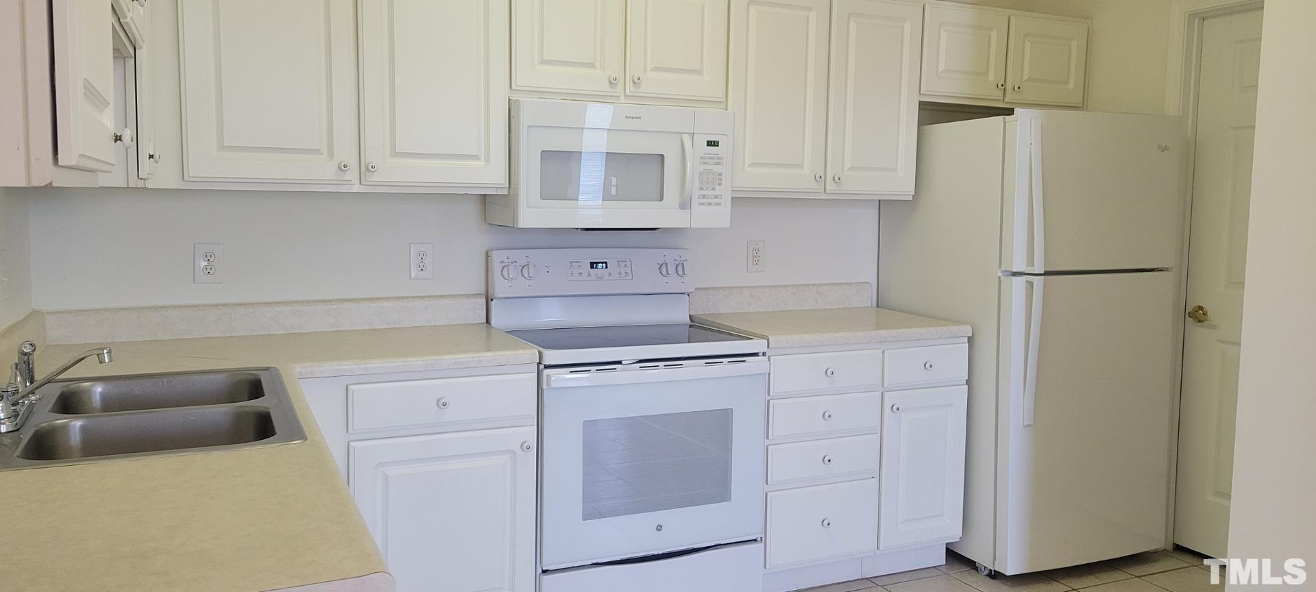 2511-301 Friedland Place Raleigh, NC 27617 - Photo 2 of 6 a kitchen with cabinets appliances and a counter space