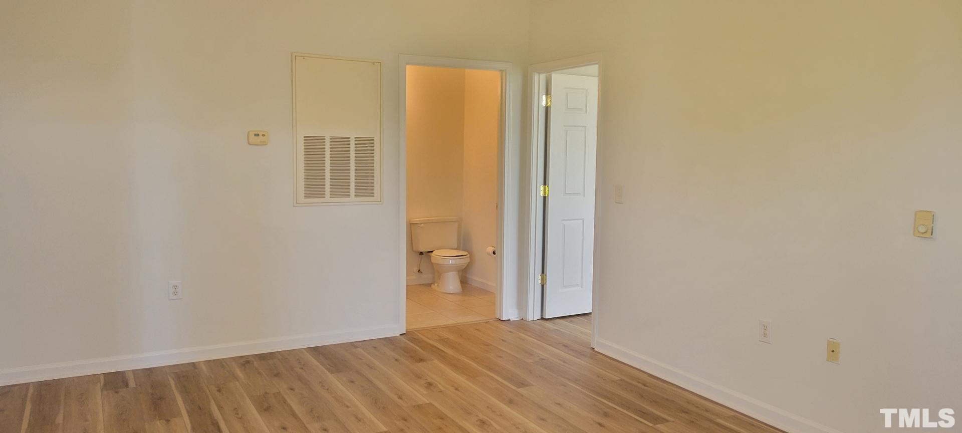 2511-301 Friedland Place Raleigh, NC 27617 - Photo 4 of 6 a view of an empty room with wooden floor and a window