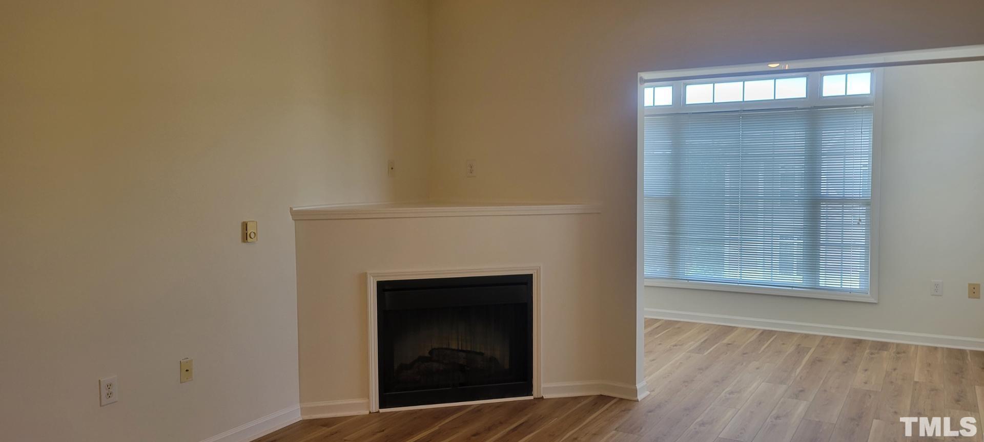 2511-301 Friedland Place Raleigh, NC 27617 - Photo 5 of 6 a view of an empty room with wooden floor and a window