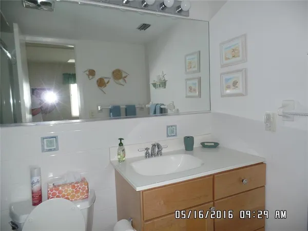 a bathroom with a sink vanity and a mirror
