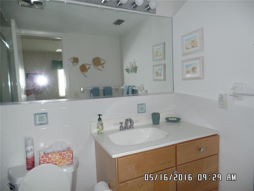 815 Ocean Shore Boulevard, Unit 9A Ormond Beach, FL 32176 - Photo 2 of 9 a bathroom with a sink vanity and a mirror