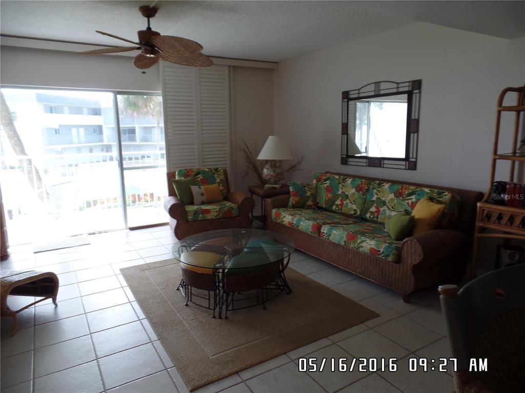 815 Ocean Shore Boulevard, Unit 9A Ormond Beach, FL 32176 - Photo 4 of 9 a living room with furniture and a window