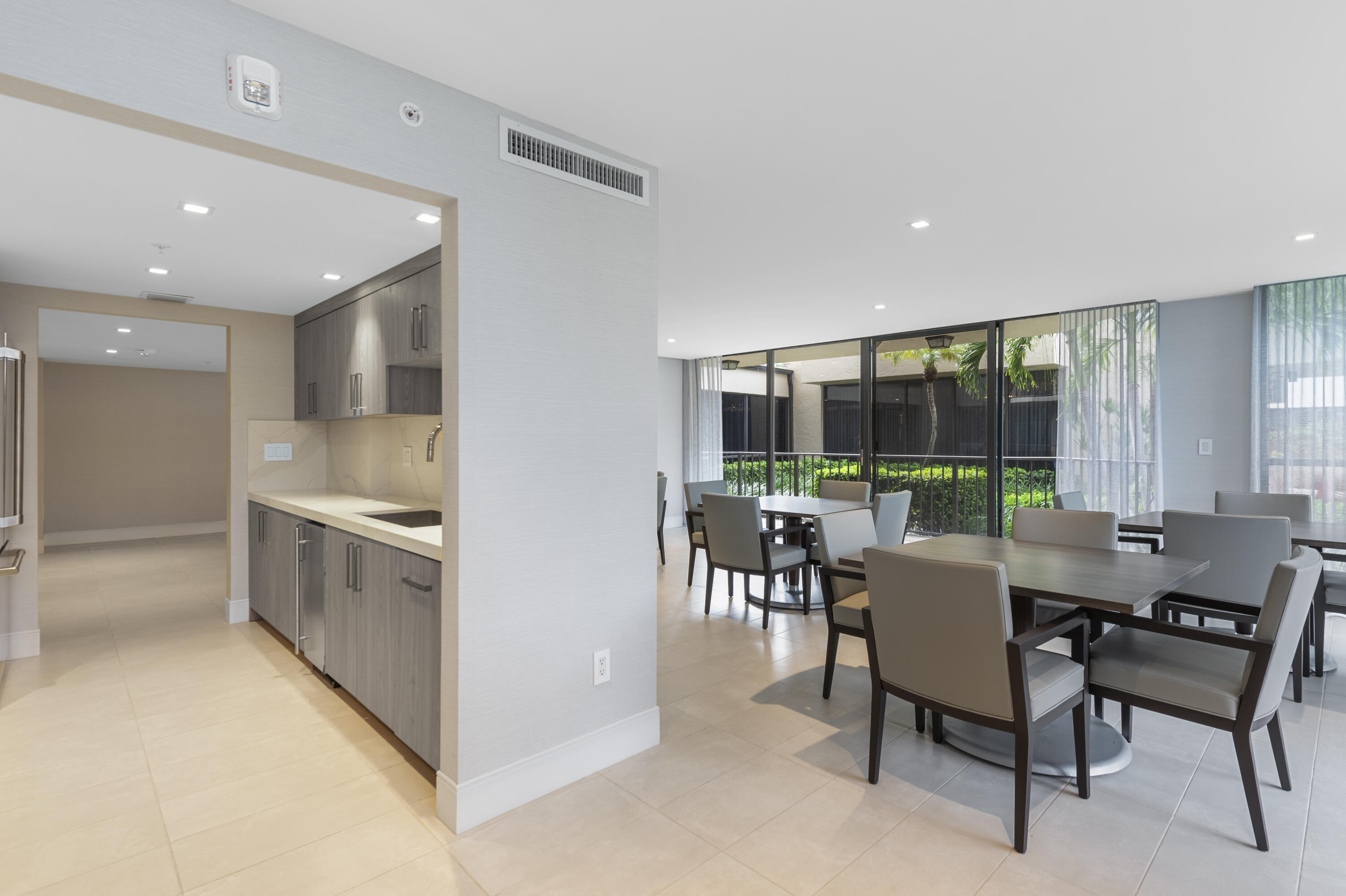 859 Jeffery Street, Unit 312 Boca Raton, FL 33487 - Photo 29 of 53 a kitchen with a table chairs and a counter top space
