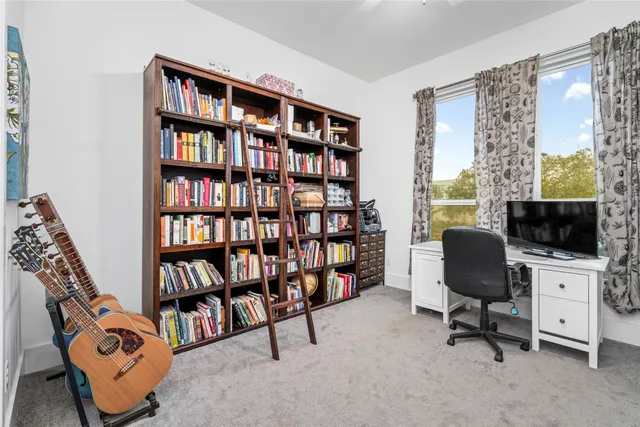 a view of a livingroom with furniture and a book shelf