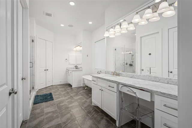 a spacious bathroom with a granite countertop sink a mirror and a shower