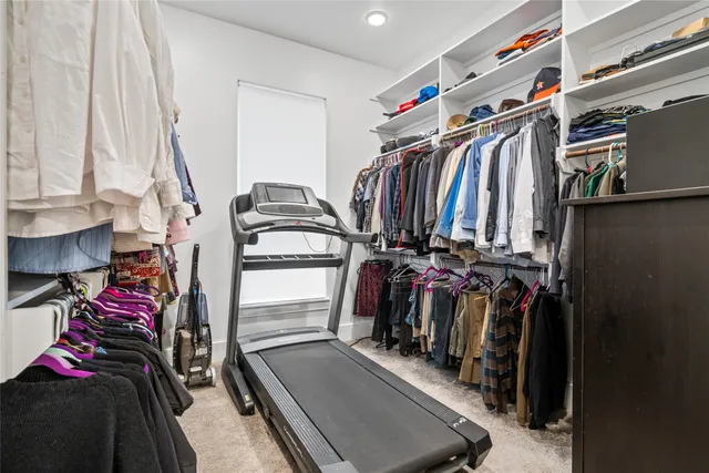 a view of walk in closet with clothes