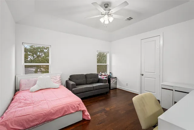 a bedroom with a bed and a couch