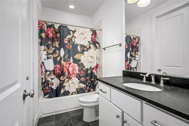 a bathroom with a sink vanity mirror and toilet