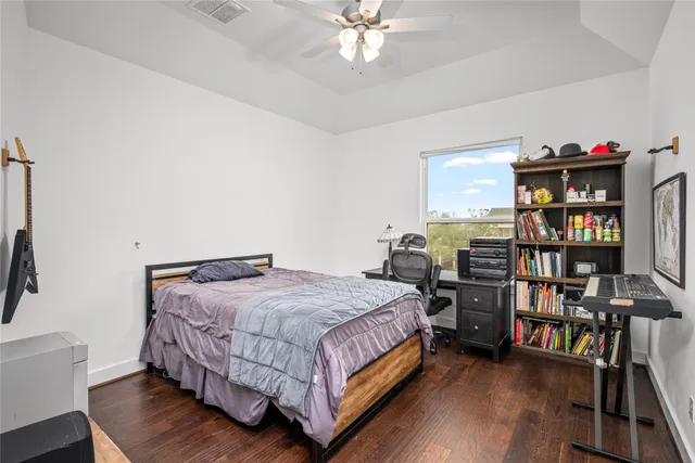 a bedroom with a bed furniture and book shelf