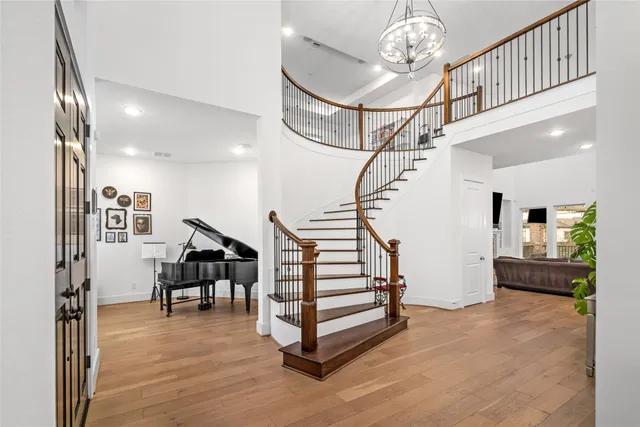 a view of entryway and hall with wooden floor
