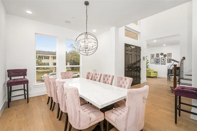 a view of a dining room with furniture wooden floor and chandelier