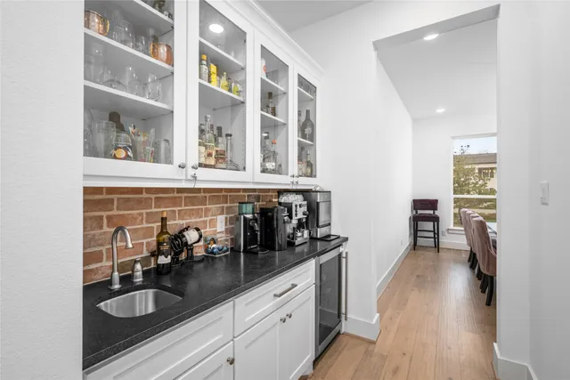 a kitchen with sink and cabinets