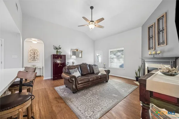 a living room with furniture and a dining table