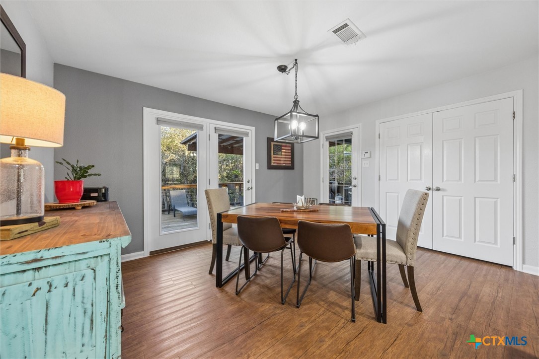 1328 Cottonwood Road Fischer, TX 78623 - Photo 13 of 35 a view of a dining room with furniture window and wooden floor