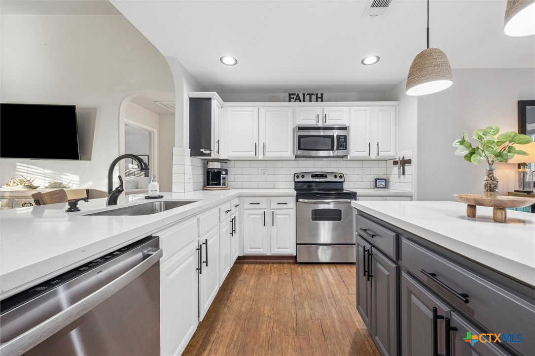1328 Cottonwood Road Fischer, TX 78623 - Photo 17 of 35 a kitchen with a sink stove and microwave