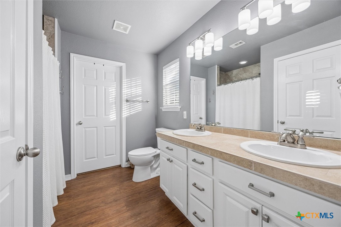 1328 Cottonwood Road Fischer, TX 78623 - Photo 20 of 35 a spacious bathroom with a granite countertop sink toilet and shower