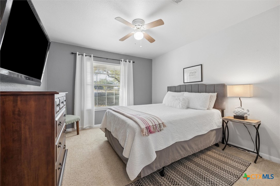 1328 Cottonwood Road Fischer, TX 78623 - Photo 22 of 35 a bedroom with a bed and a flat screen tv