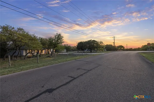 a view of a street with a yard