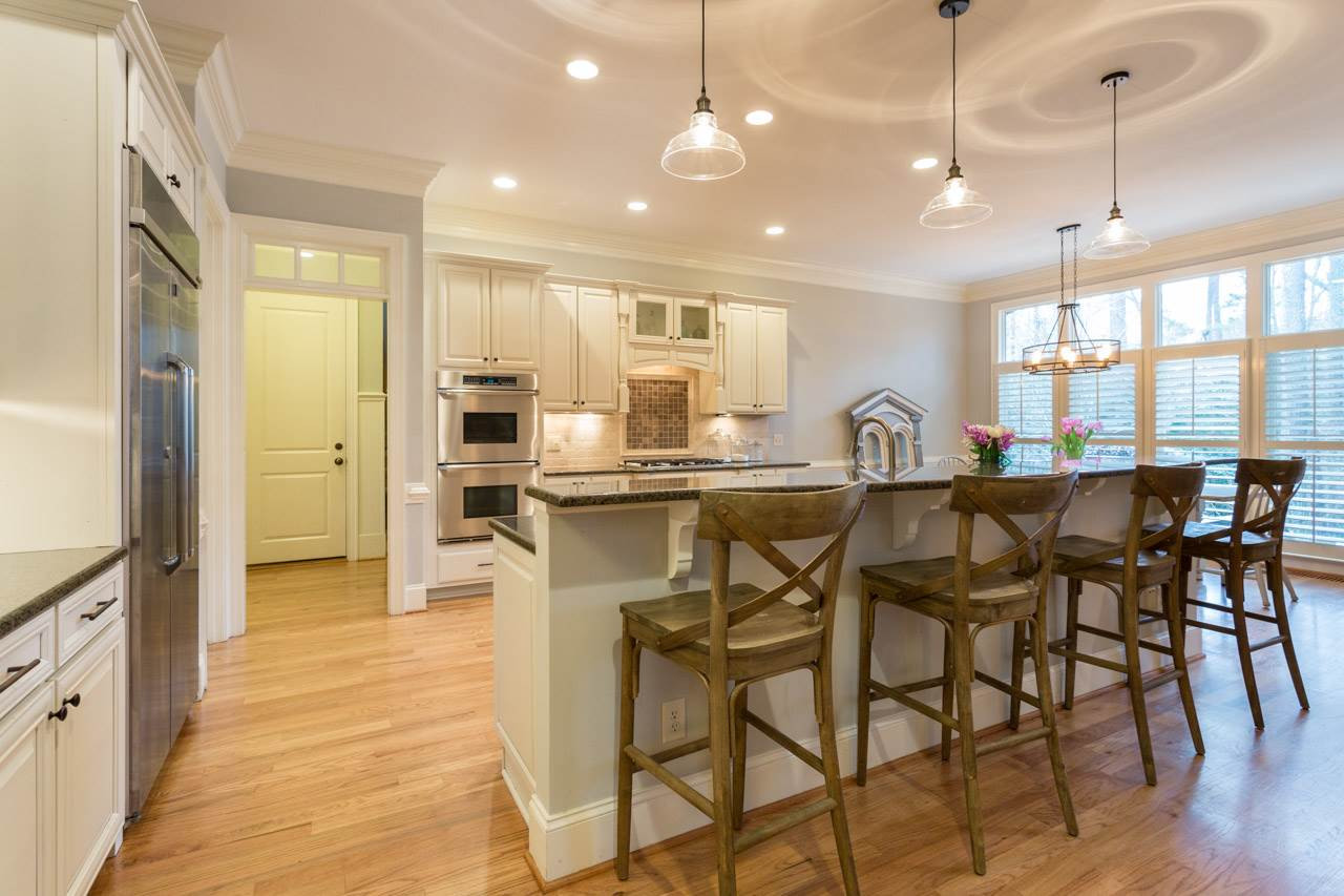 3215 Rain Forrest Way Raleigh, NC 27614 - Photo 4 of 30 Creamy white cabinets, stainless appliances, granite counters and under cabinet lighting. Remarkable Kitchen