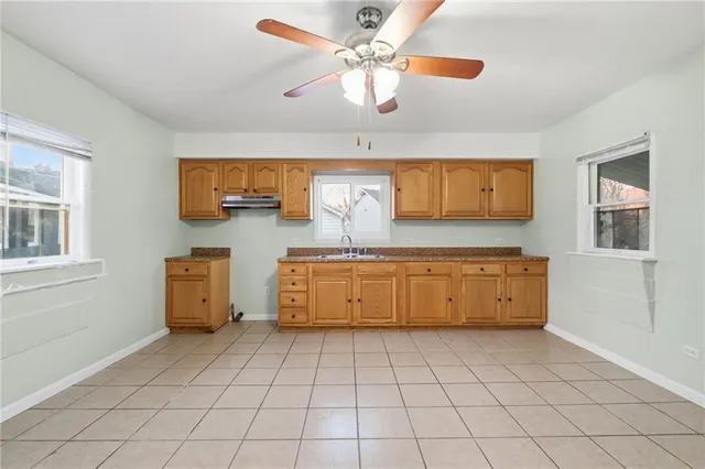 a kitchen with stainless steel appliances granite countertop a sink and cabinets