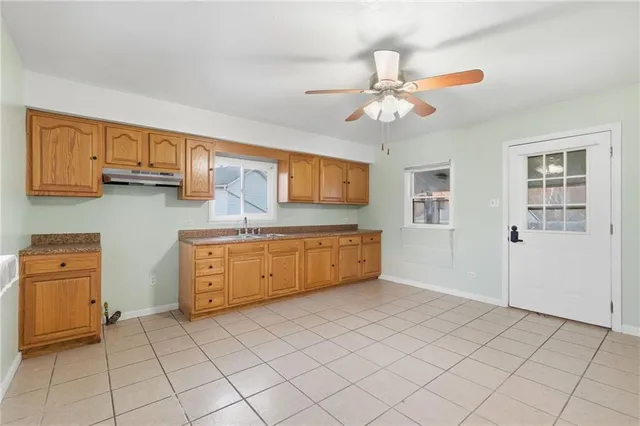 a kitchen with stainless steel appliances granite countertop a sink and cabinets