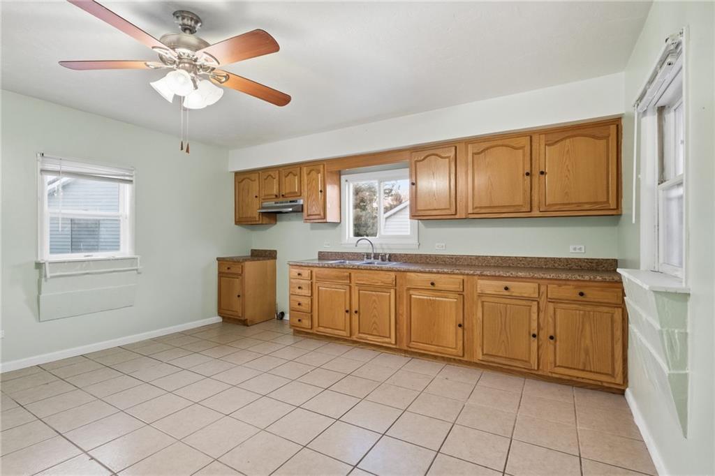 518 Cross Street Rochester, PA 15074 - Photo 13 of 24 a kitchen with granite countertop a sink cabinets stainless steel appliances and a window