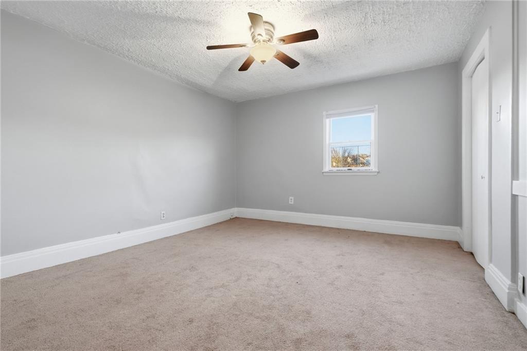 518 Cross Street Rochester, PA 15074 - Photo 18 of 24 an empty room with a window and a fan