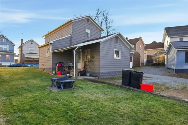 a front view of a house with a yard and a garage