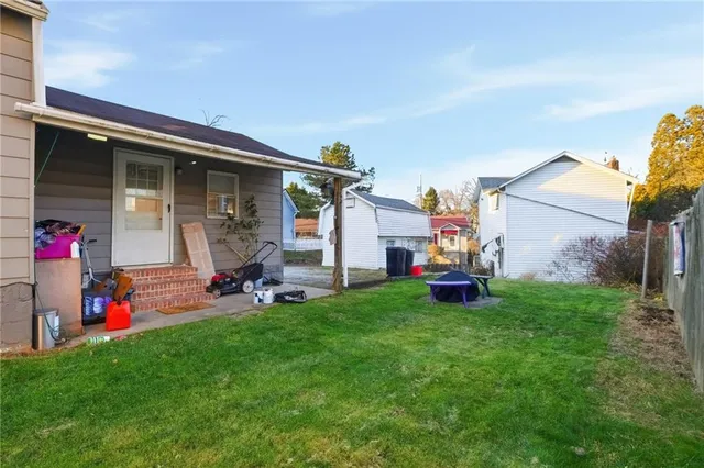 a view of a house with a backyard and a porch