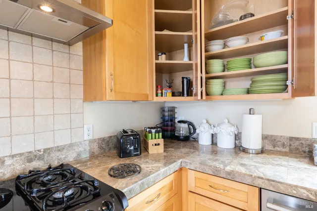 a kitchen with a stove and a cabinets