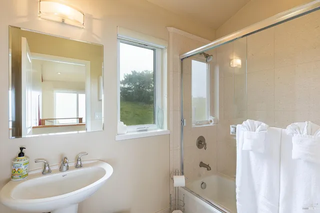 a bathroom with a sink toilet and mirror