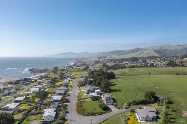an aerial view of a houses with a lake