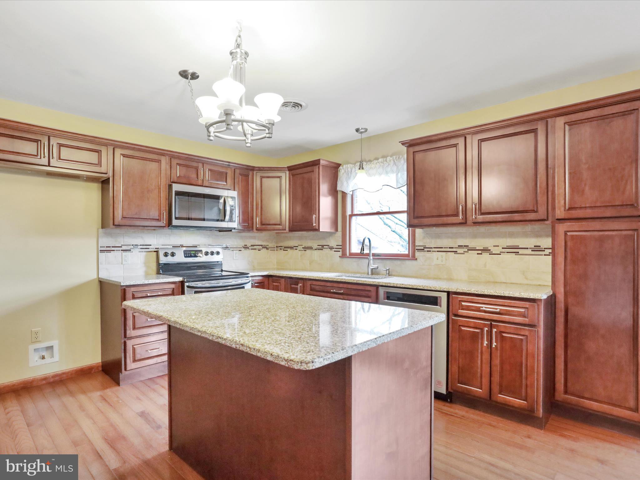 47 Diffys Drive Shippensburg, PA 17257 - Photo 4 of 48 a kitchen with kitchen island granite countertop wooden cabinets and a sink
